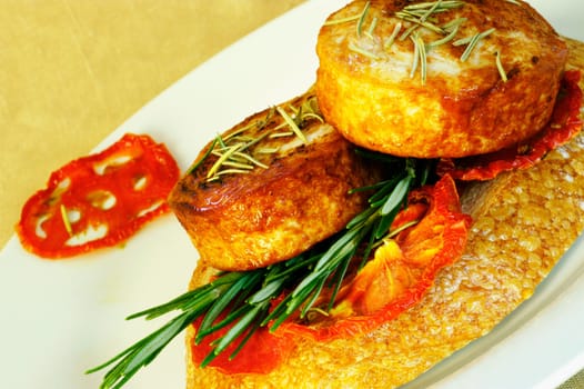 Close-up of roast meat with rosemary on a plate