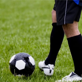 Low section view of a soccer player with a soccer ball