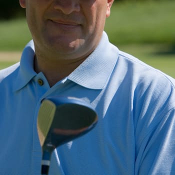Close-up of a mature man holding a golf club