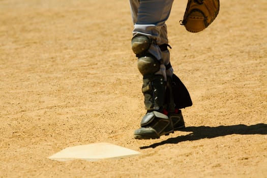 Low section view of a baseball player near a baseball diamond