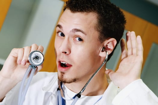 Close-up of a male doctor listening with a stethoscope