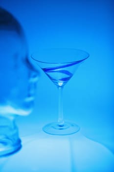 Martini glass near a glass mannequin