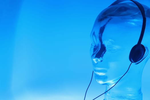 Close-up of a glass mannequin wearing headphones
