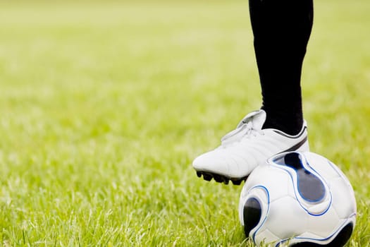 Close-up of a personŽs leg near a soccer ball
