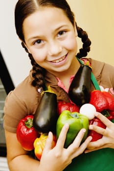 Portrait of a girl holding vegetables and smiling