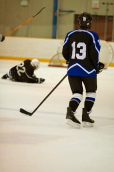 Rear view of an ice hockey player playing ice hockey