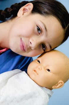 Portrait of a girl carrying a child and smiling