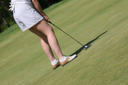 Low section view of a woman playing golf