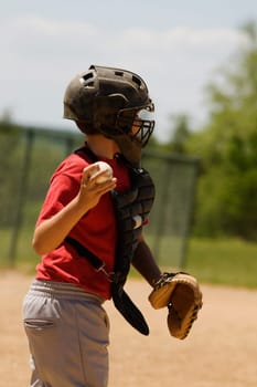 Side profile of a baseball catcher throwing a baseball