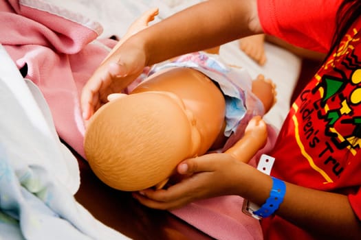 Close-up of childŽs hands holding a doll