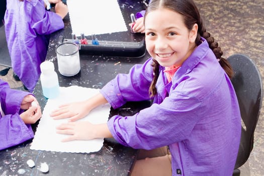 High angle view of a girl with her hands on the table for a manicure