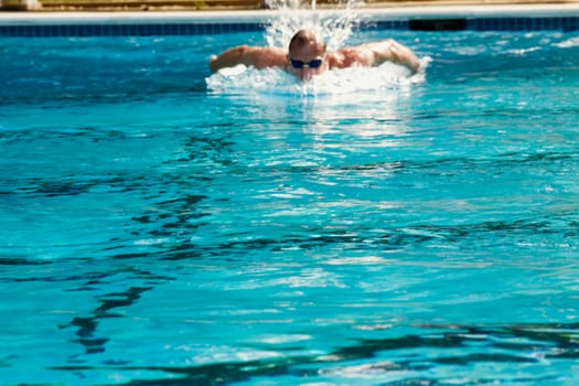 Mid adult man swimming in a swimming pool