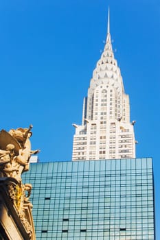 Low angle view of a sculpture in font of a skyscraper, Empire State Building, New York City, New York State, USA