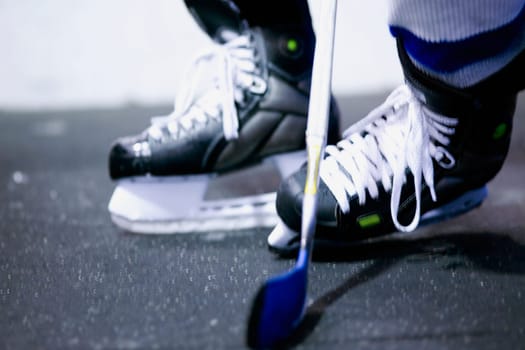 Low section view of an ice hockey player playing ice hockey