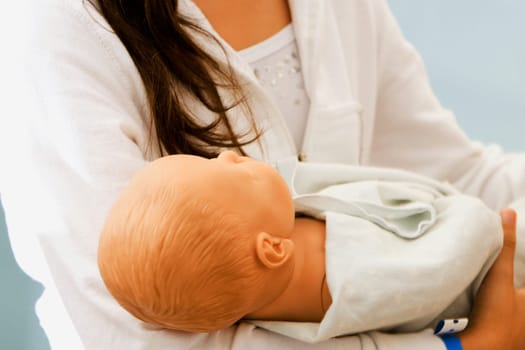 Close-up of a woman carrying a doll