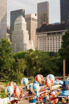 Amusement park ride in front of skyscrapers