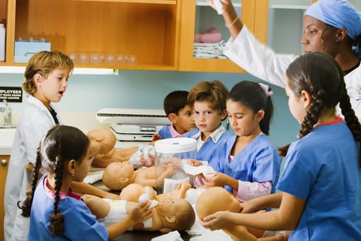 Boys and girls changing the diapers of dolls