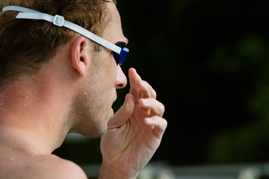 Close-up of a mid adult man wearing swimming goggles