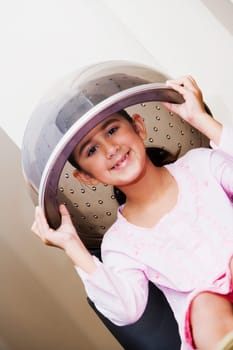 Portrait of a girl sitting under a hair dryer