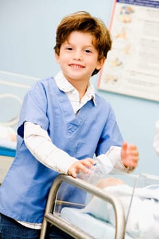Portrait of a boy holding a baby bottle