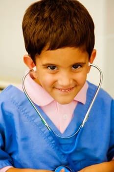 Portrait of a boy listening to his heartbeats with a stethoscope