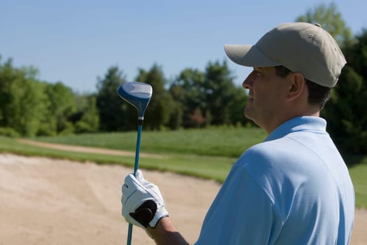 Close-up of a mature man holding a golf club