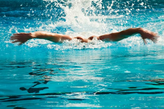 Mid adult man swimming in a swimming pool