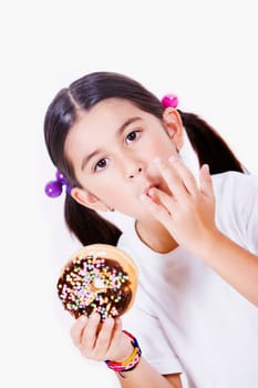 Portrait of a girl holding a donut and licking her finger