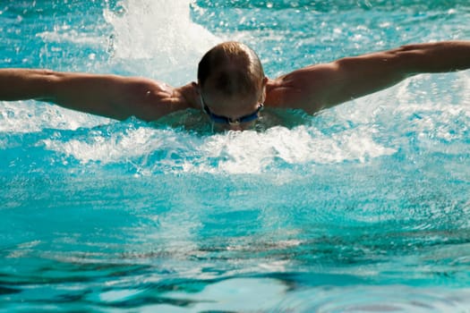 Mid adult man swimming in a swimming pool