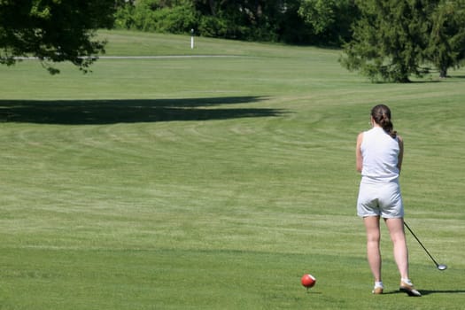 Rear view of a woman playing golf