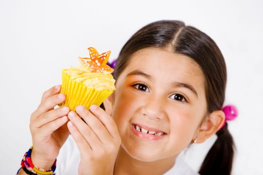 Portrait of a girl holding a cupcake