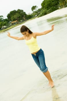 Girl standing in a lake with her arms outstretched