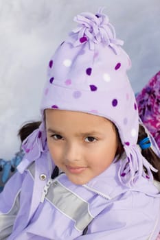 Portrait of a girl sitting in snow