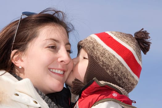 Close-up of a boy kissing his mother