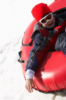 High angle view of a child sitting in an inner tube