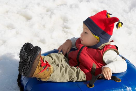 Boy reclining in an inner tube