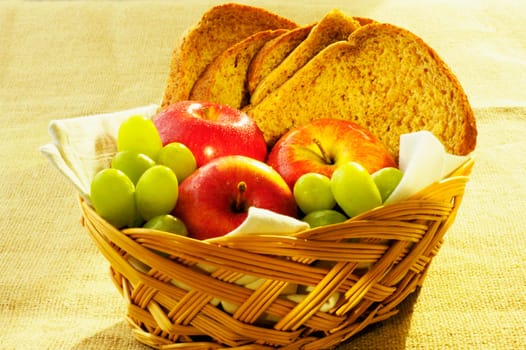 Close-up of fruit and brown bread in a basket