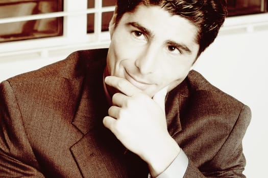 Close-up of a businessman with his hand on his chin