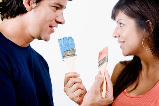 Close-up of a couple holding paintbrushes