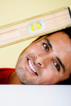 Portrait of a young man smiling with a level