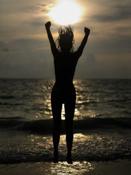 Silhouette of a young woman jumping