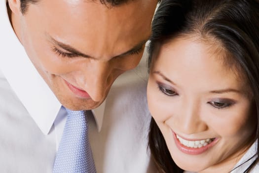 Close-up of a businessman and a businesswoman looking down