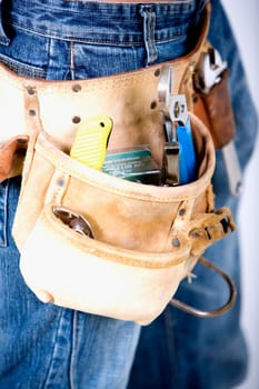 Mid section view of a man wearing a tool belt