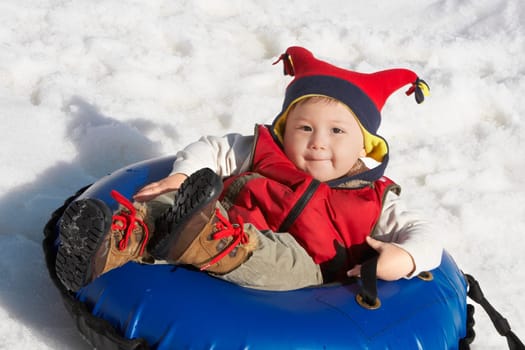 Portrait of a boy reclining on an inner tube