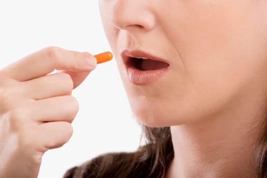 Close_up of a patient taking a capsule