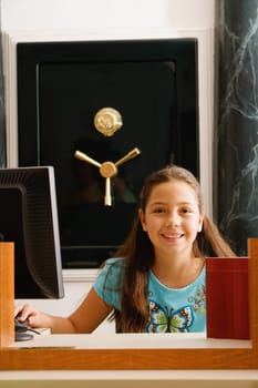 Portrait of a girl sitting in front of a safe