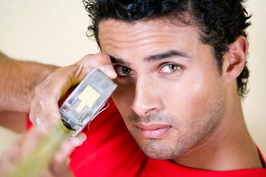 Portrait of a young man holding a measuring tape