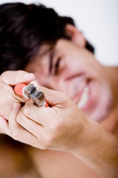 Close-up of a mid adult man holding pliers