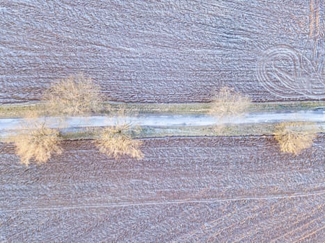 winter road, landscape covered by morning frost, top down aerial view, landscape. Simplicity concept landscape composition.