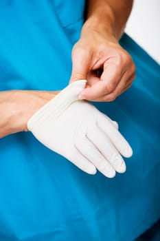 Close-up of a male surgeonŽs hand removing a surgical glove from his hand